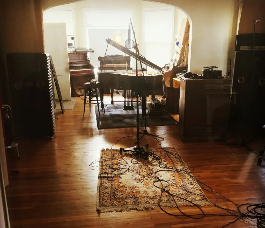 Recording studio with a grand piano, organ, and a microphone